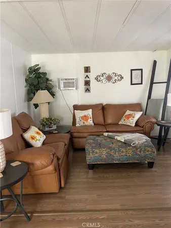 a bedroom with furniture and wooden floor