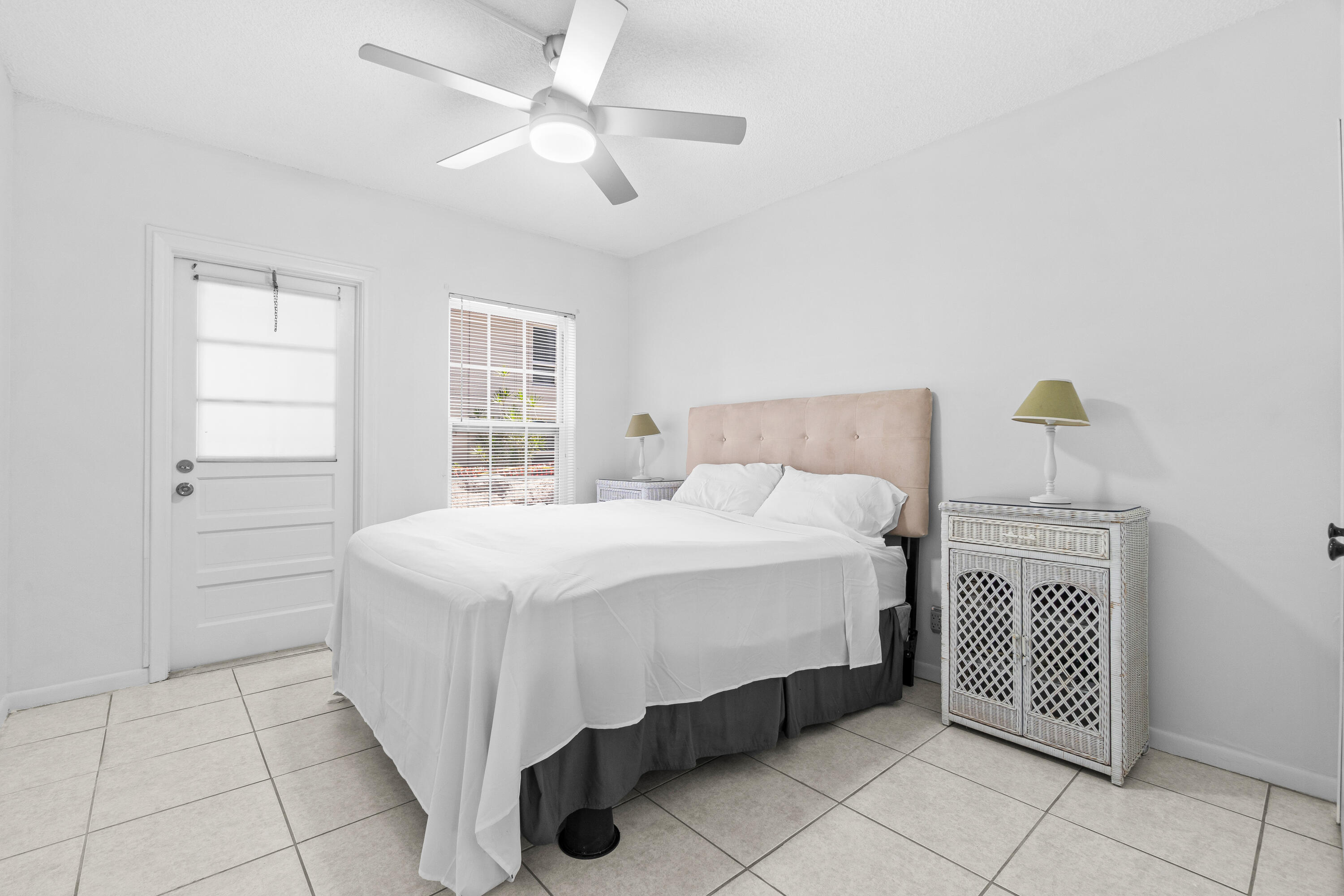 250 Northeast 20th Street, Unit 1220 Boca Raton, FL 33431 - Photo 16 of 25 a bedroom with a bed and a chandelier