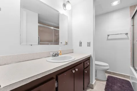 a bathroom with a sink a toilet a mirror and vanity