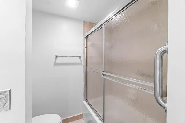a bathroom with a glass shower door