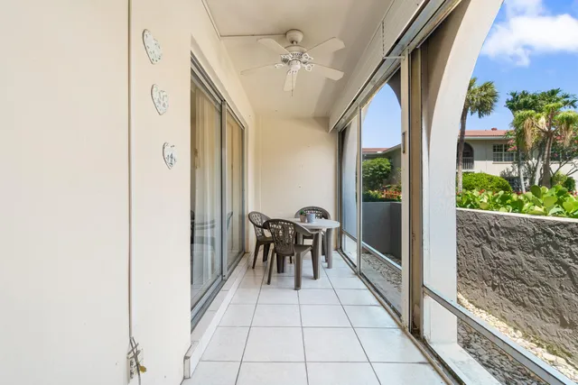 a view of a patio with table and chairs and potted plants