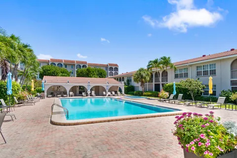a view of swimming pool with outdoor seating and plants