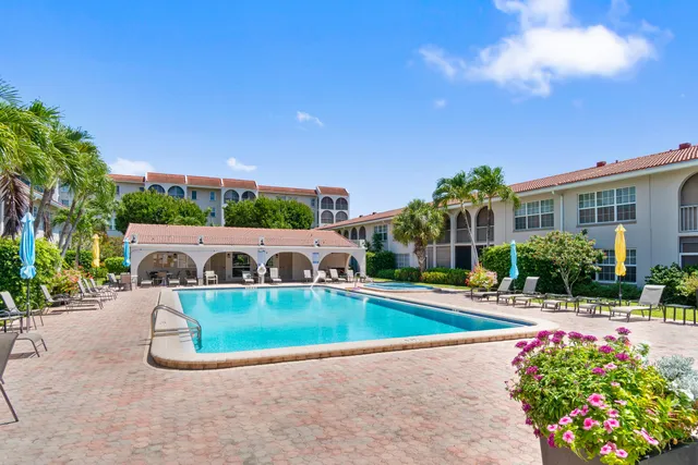 a view of swimming pool with outdoor seating and plants