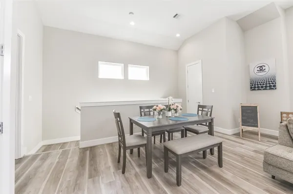 a view of a dining room with furniture and wooden floor