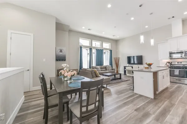 a view of kitchen with sink dining table and chairs