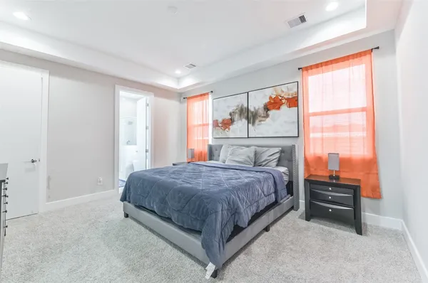a spacious bedroom with a bed and a window