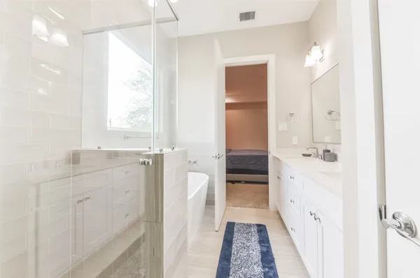 a bathroom with a sink a mirror and a shower