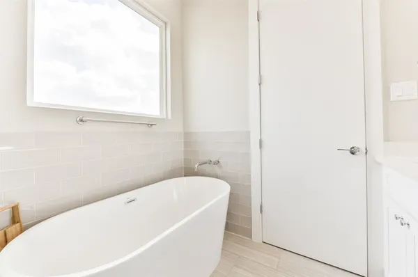 a bathroom with a bathtub and window