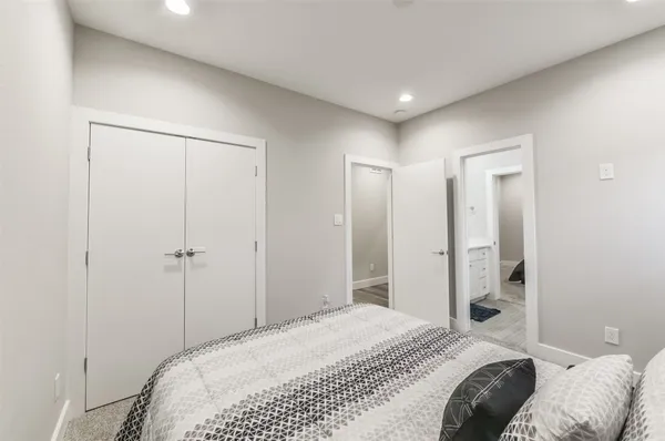 a bedroom with a bed and a mirror