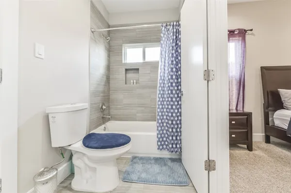 a bathroom with a toilet and a shower