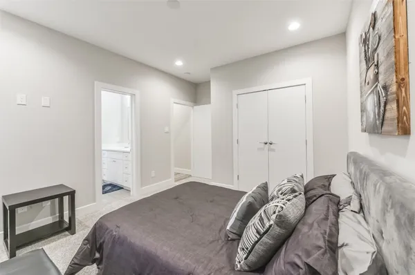 a bedroom with a bed and a painting