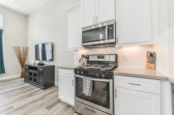a kitchen with a stove and a microwave