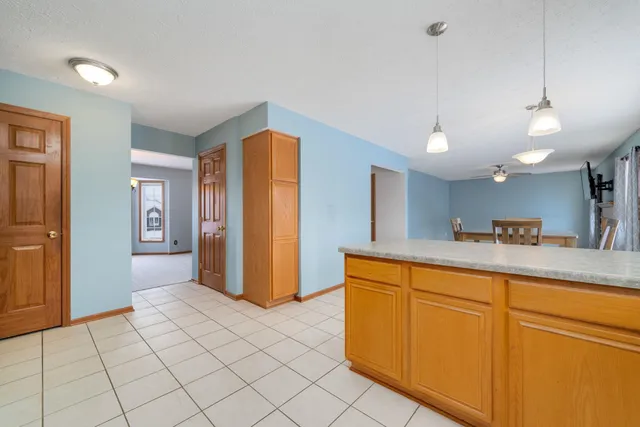 a view of a kitchen with cabinets and wooden floor