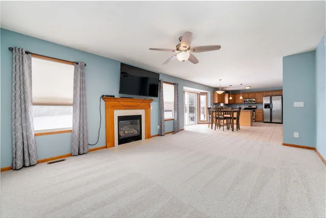 a view of livingroom with furniture fireplace and a window