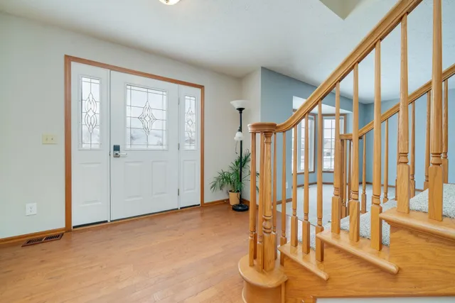 a view of entryway with wooden floor and door
