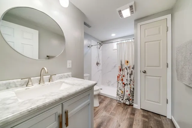 a bathroom with a double vanity sink and mirror