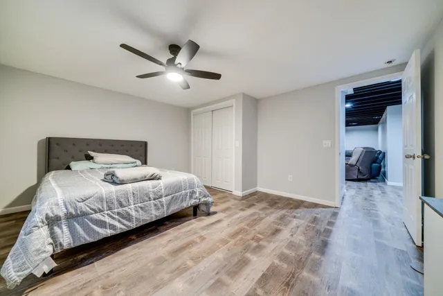 a bedroom with a bed and a ceiling fan