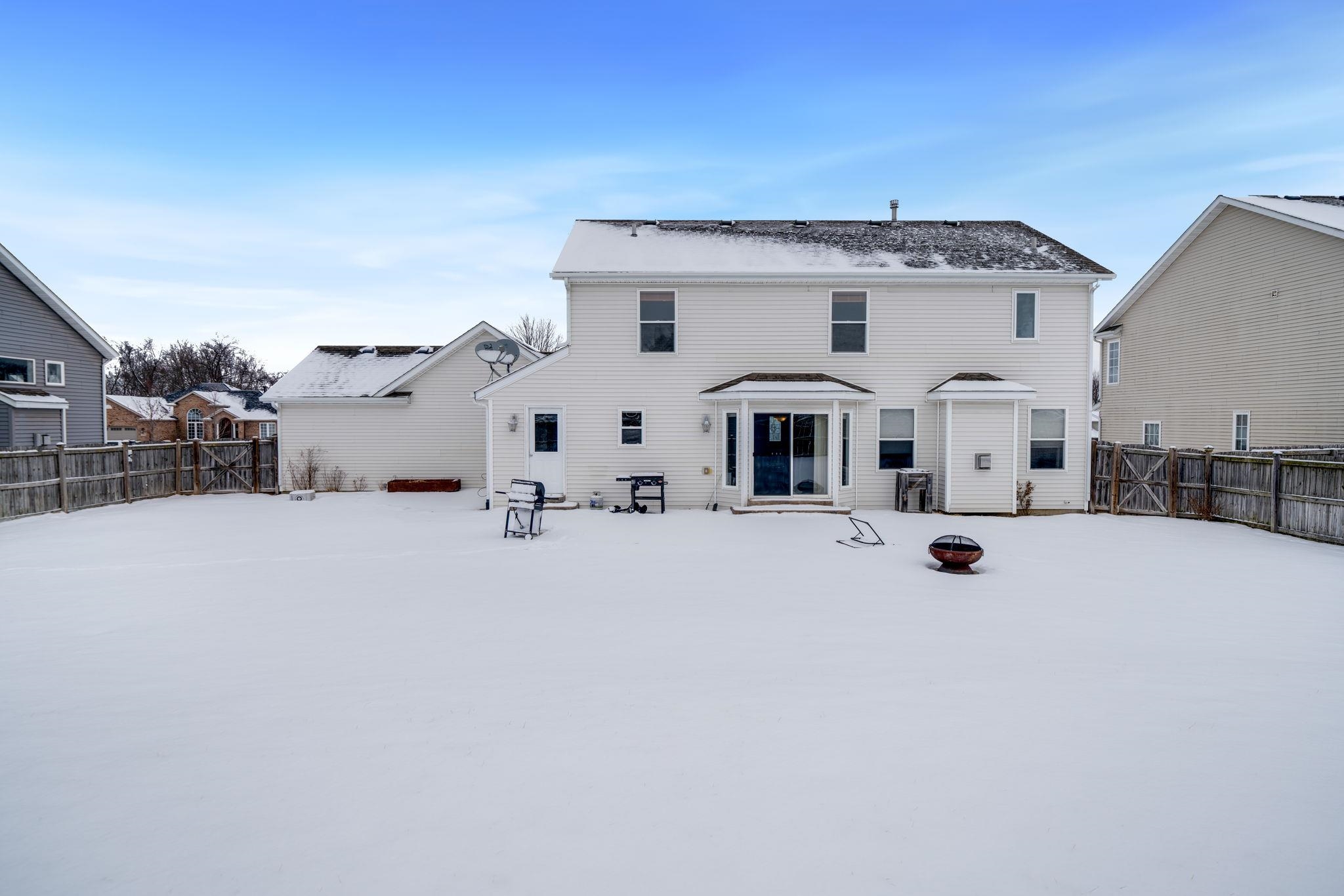 11062 Chicory Ridge Way Roscoe, IL 61073 - Photo 42 of 43 a view of a white house with a snow in the background