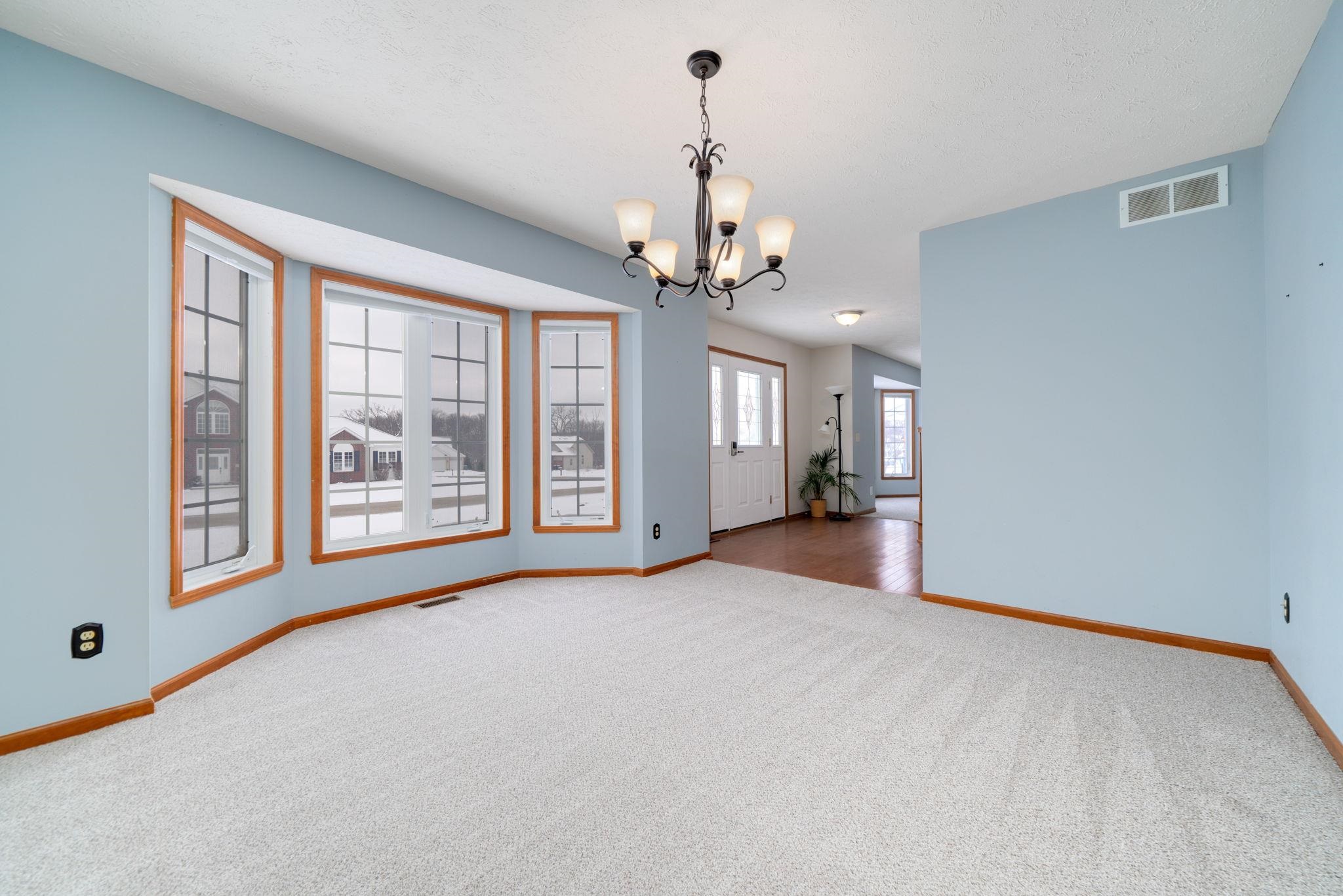 11062 Chicory Ridge Way Roscoe, IL 61073 - Photo 9 of 43 a view of a big room with windows and chandelier
