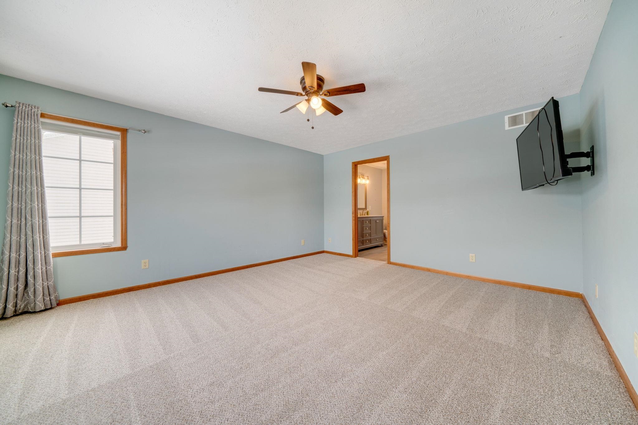 11062 Chicory Ridge Way Roscoe, IL 61073 - Photo 10 of 43 an empty room with windows and ceiling fan