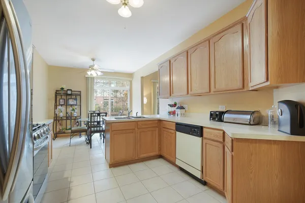 a kitchen with cabinets and chairs