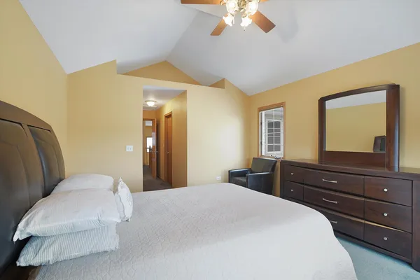 a bedroom with a bed and a chandelier