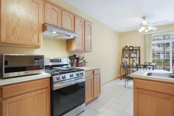 a kitchen with stainless steel appliances a stove a sink and a microwave