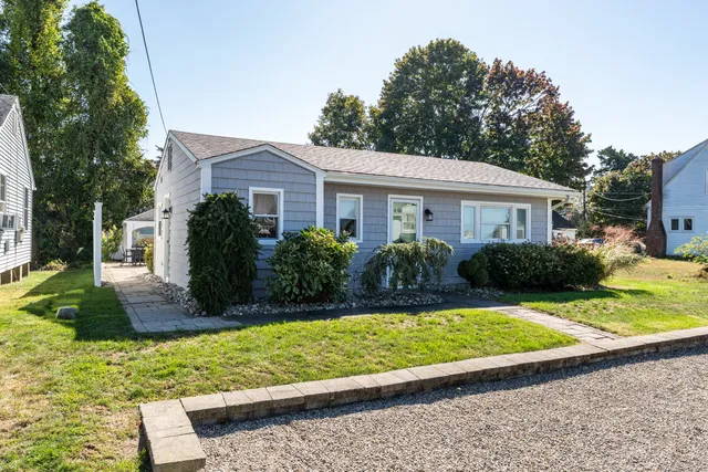a front view of a house with a yard