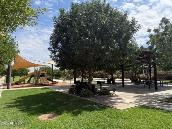 a view of outdoor space with garden and tree