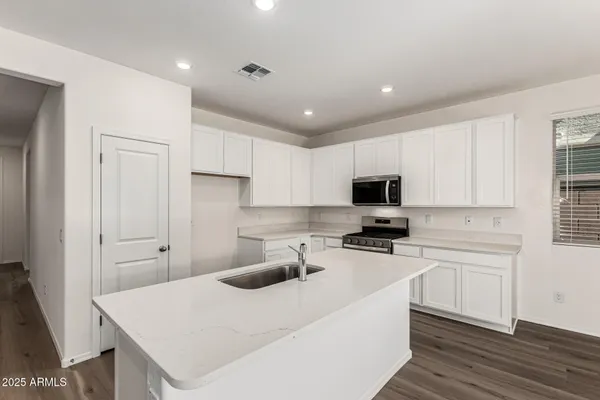 a kitchen with a sink a stove and refrigerator
