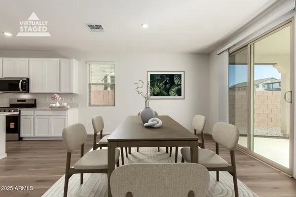 a view of a dining room with furniture and wooden floor