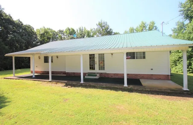 a view of a house with pool porch and wooden fence