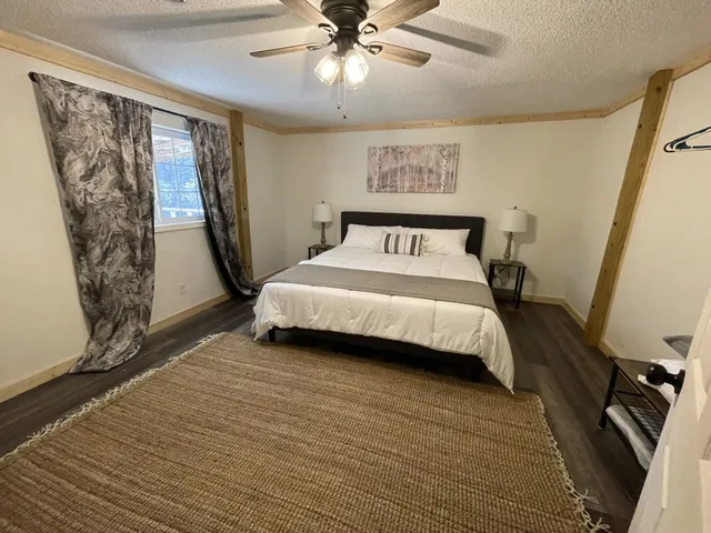 a bedroom with a bed and a window