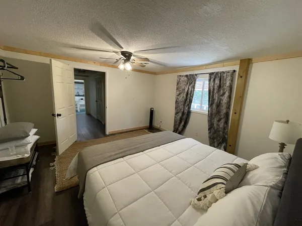 a bedroom with a large bed and a chandelier