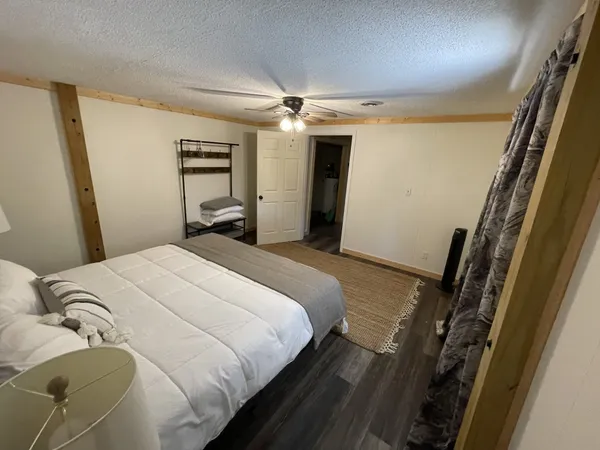 a bedroom with a bed and a mirror