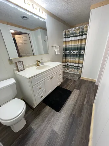 a bathroom with a sink toilet and shower