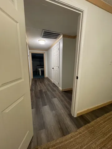 a view of hallway with wooden floor