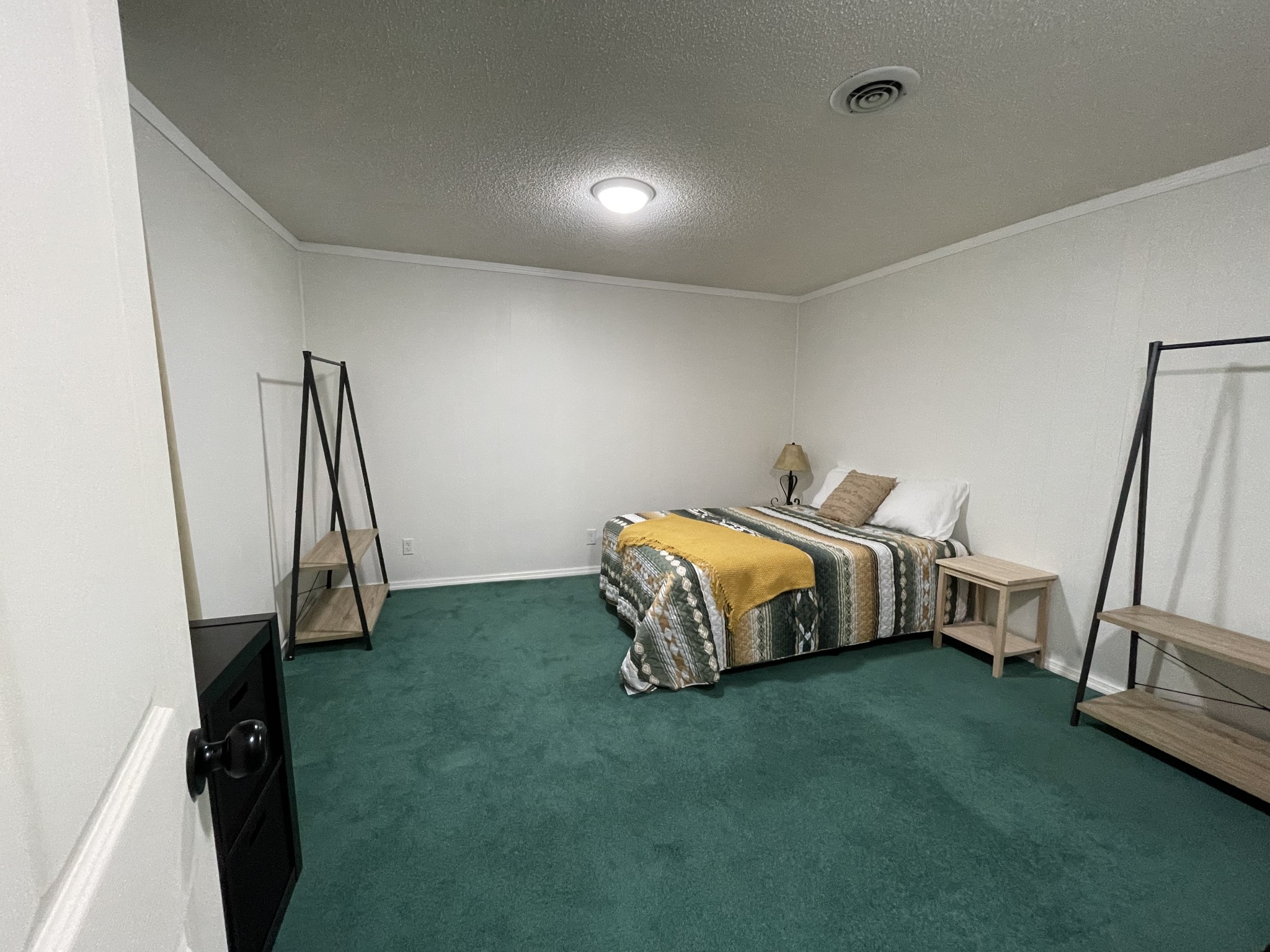 4875 Dollar Road Buena Vista, TN 38318 - Photo 20 of 29 a bedroom with a bed and a flat tv screen on the dresser