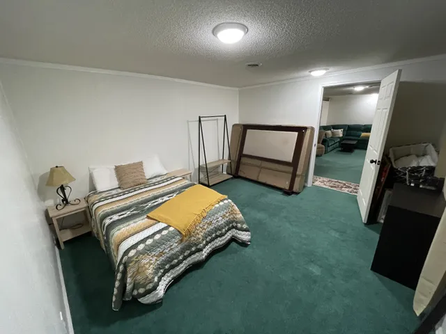 a bed room with a bed and a television