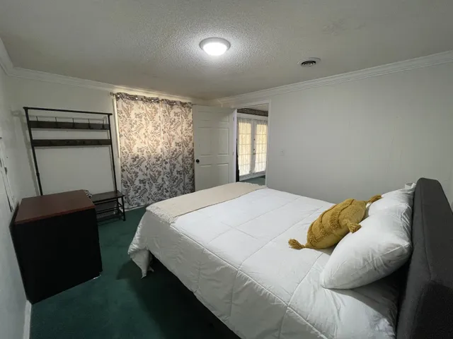 a bedroom with a bed and a chair