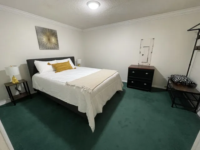 a bed sitting in a bedroom next to a window