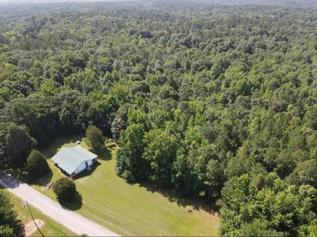 an aerial view of a house with a yard