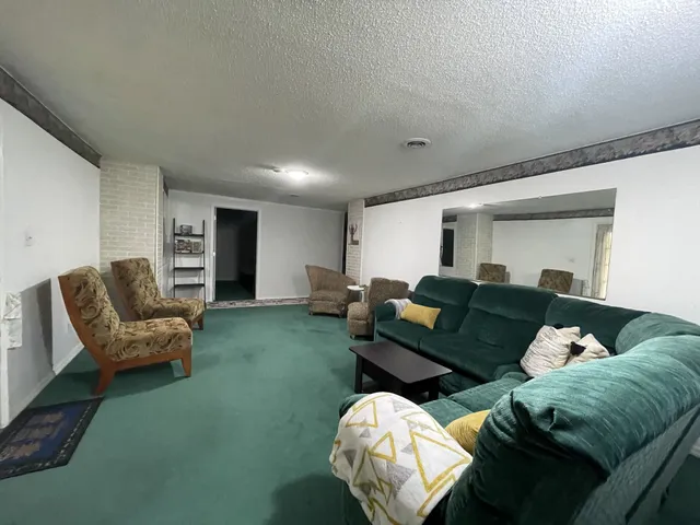 a living room with furniture and a hard wood floor