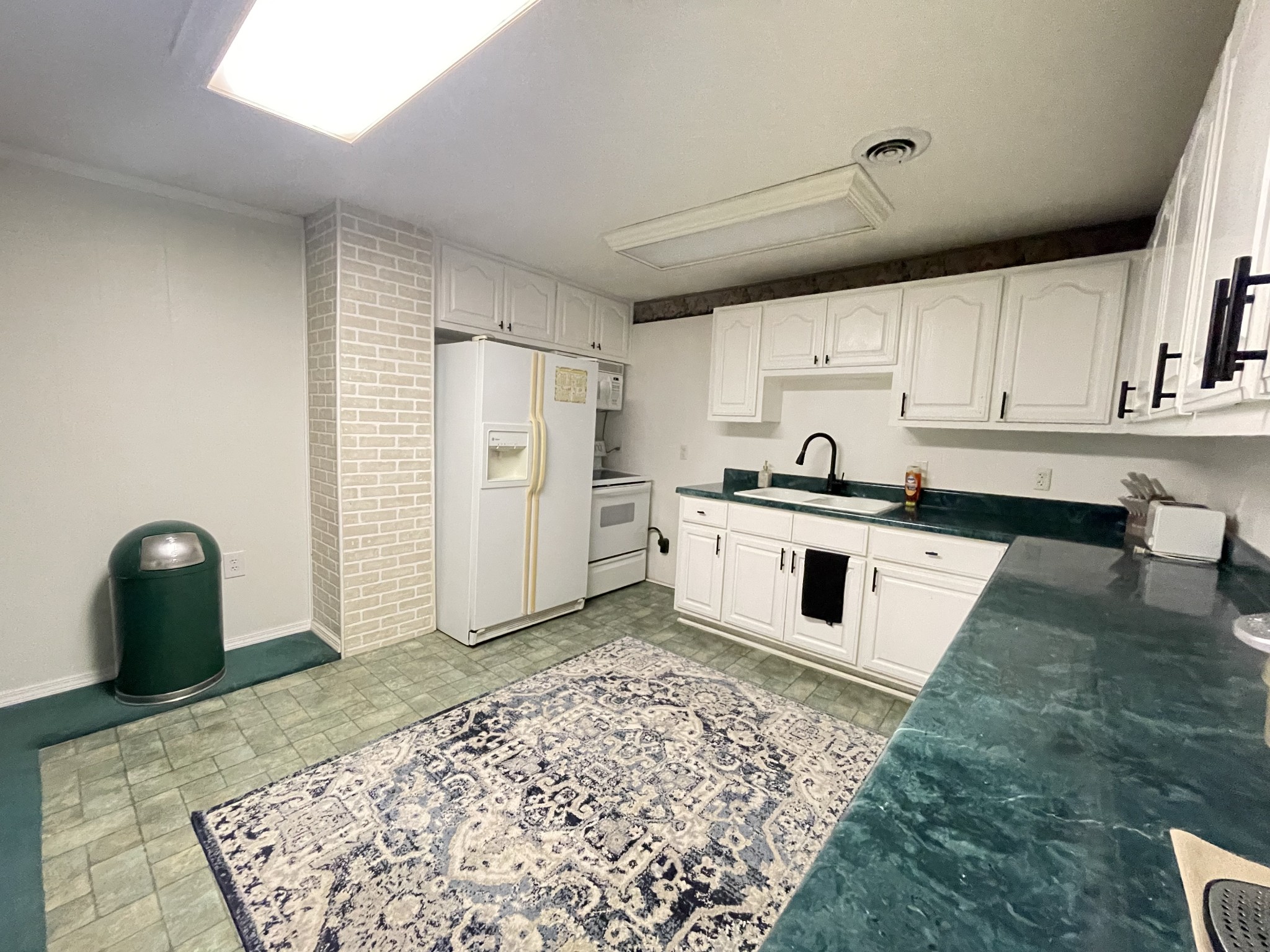 4875 Dollar Road Buena Vista, TN 38318 - Photo 8 of 29 a kitchen with granite countertop a sink cabinets and stainless steel appliances