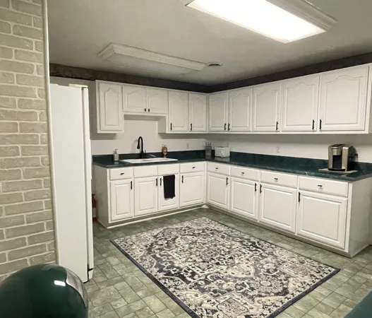 a kitchen with stainless steel appliances granite countertop a refrigerator sink and cabinets