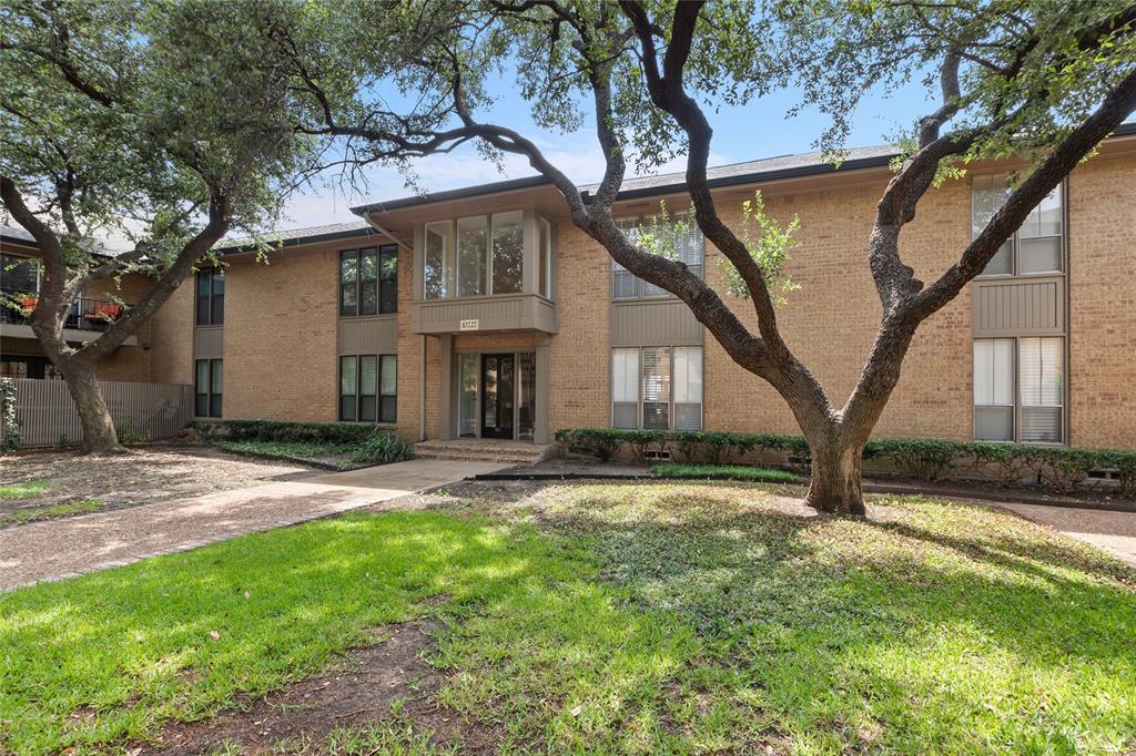 10727 Villager Road, Unit C Dallas, TX 75230 - Photo 2 of 39 Townhome / multi-family property with brick siding and a front yard