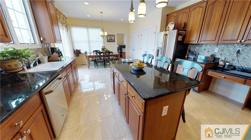 39 Zaitz Farm Road West Windsor, NJ 08550 - Photo 7 of 24 a kitchen with sink refrigerator and cabinets