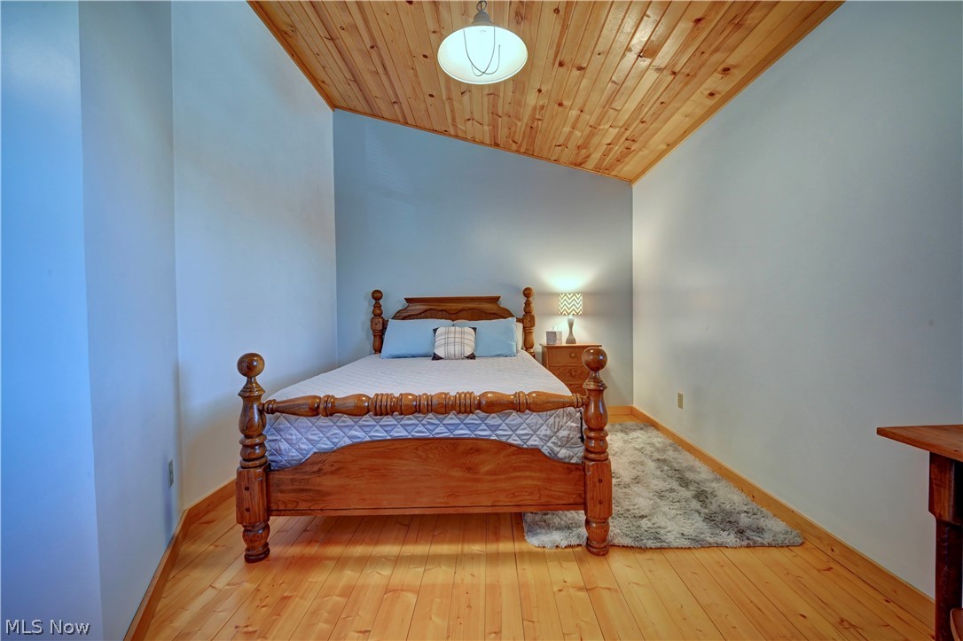 8045 McFadden Road Shreve, OH 44676 - Photo 32 of 45 Bedroom with light wood finished floors and a vaulted wooden ceiling