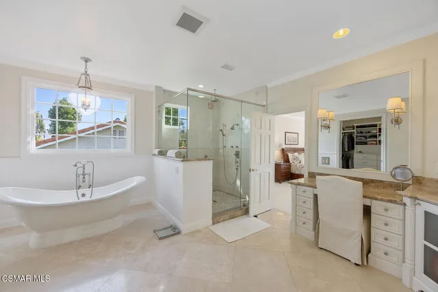 a spacious bathroom with a double vanity sink a mirror and a bathtub
