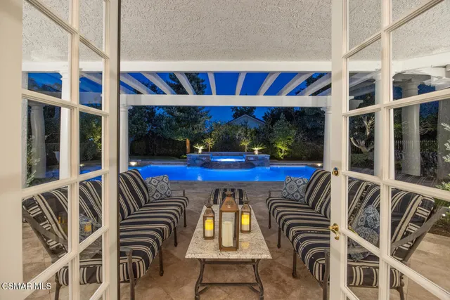 a view of a chairs and table in patio
